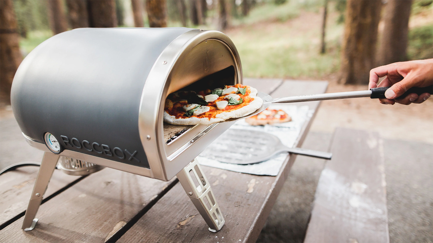 gozney roccbox pizza oven for your backyard and camping table top with pizza