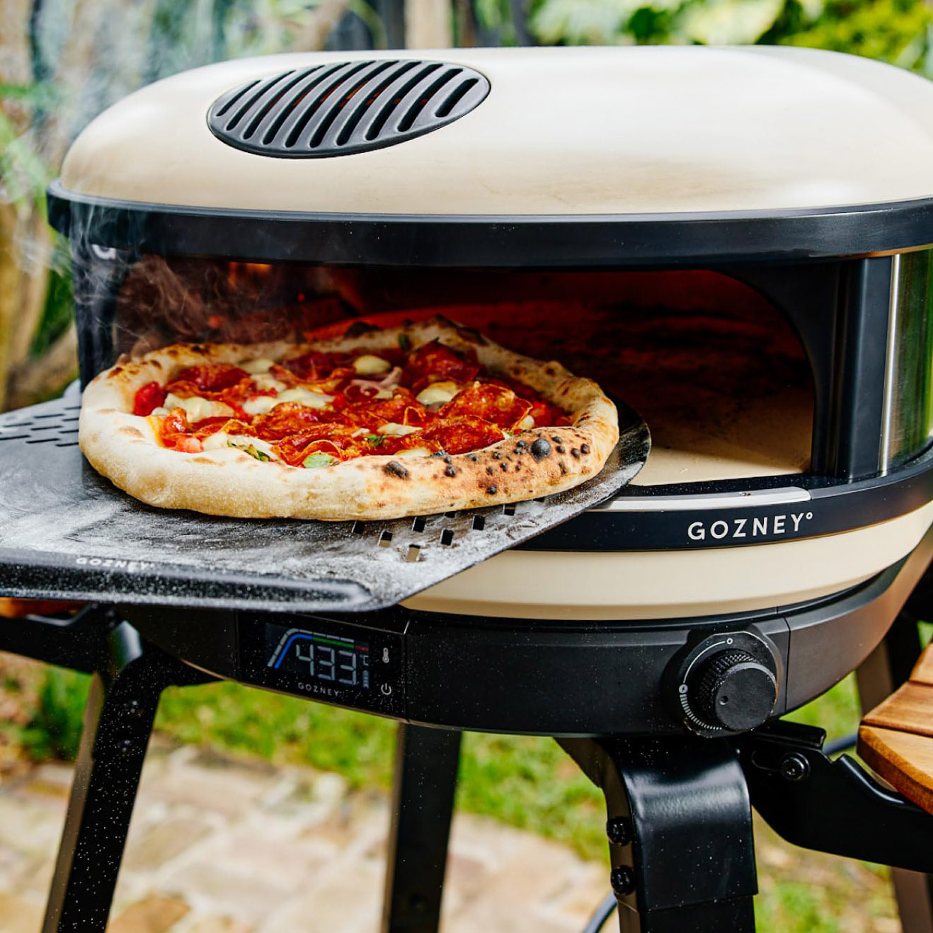 gozney arc pizza oven with pizza