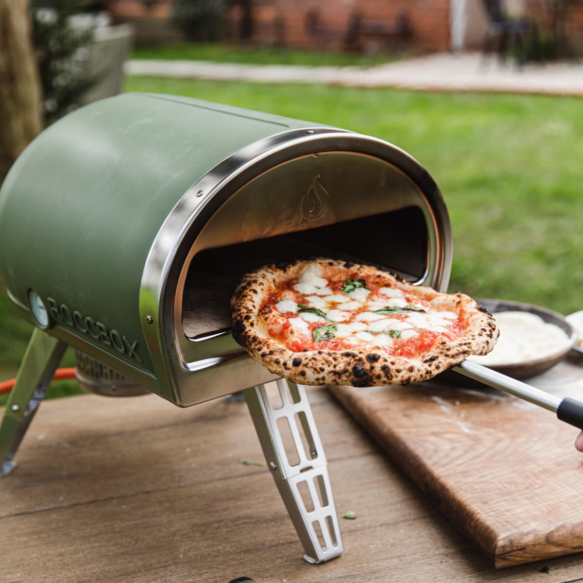 Gozney roccbox portable pizza oven with pizza